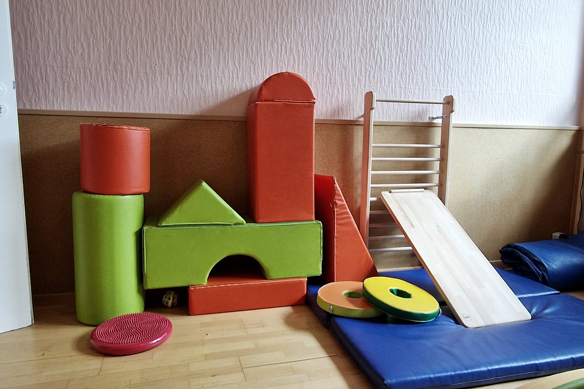 Aufgebaute Kletterlandschaft aus großen Schaumstoffbausteinen mit Rutschbrett.
